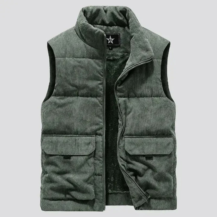 Green corduroy vest with a brand logo on a light gray background